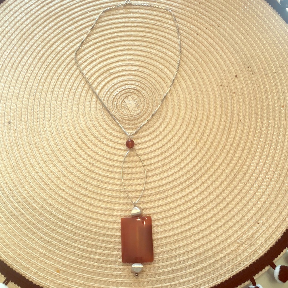 Brick colored glass pendant on silver chain
